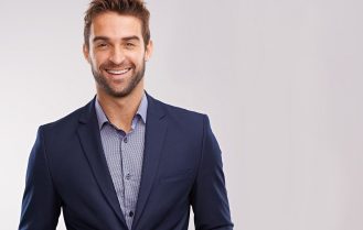 Handsome well-dressed man against a gray background